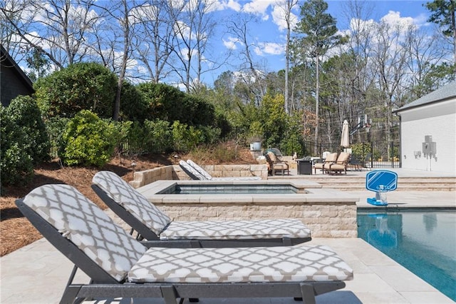 outdoor pool with a patio area and fence