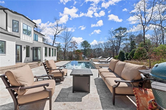 view of patio / terrace featuring an outdoor pool, a grill, and outdoor lounge area