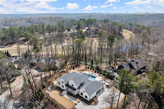 drone / aerial view featuring a forest view