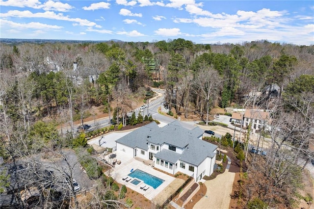 drone / aerial view featuring a view of trees