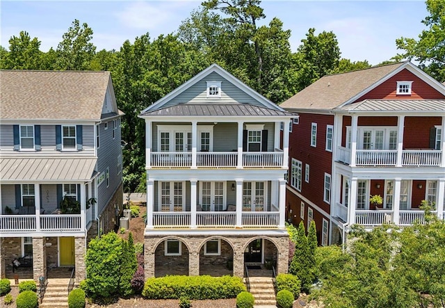 2059 Wheaton Way, Atlanta, GA 30328 - rear view of property with a balcony, covered porch, a standing seam roof, metal roof, and stairs