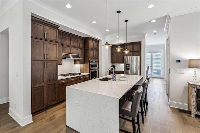 2059 Wheaton Way, Atlanta, GA 30328 - kitchen with appliances with stainless steel finishes, a sink, baseboards, a kitchen island with sink, and recessed lighting