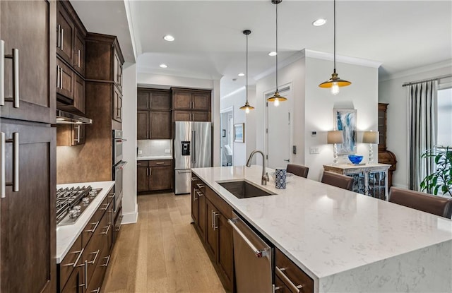 2059 Wheaton Way, Atlanta, GA 30328 - kitchen with a sink, stainless steel appliances, ornamental molding, a spacious island, and light wood-type flooring