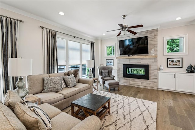 2059 Wheaton Way, Atlanta, GA 30328 - living room featuring ornamental molding, ceiling fan, a large fireplace, wood finished floors, and recessed lighting