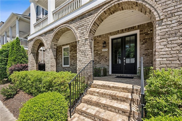 2059 Wheaton Way, Atlanta, GA 30328 - property entrance featuring french doors, brick siding, and a balcony