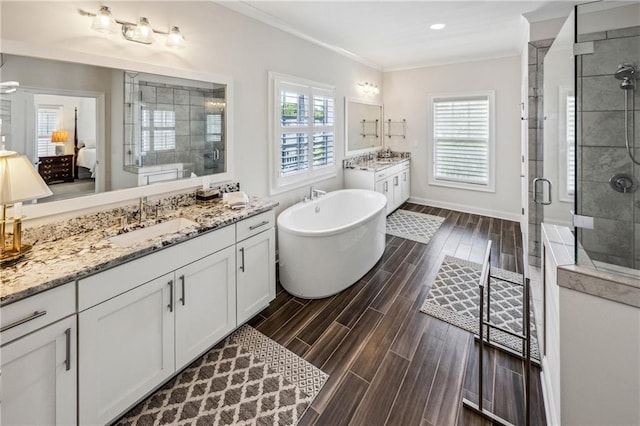2059 Wheaton Way, Atlanta, GA 30328 - ensuite bathroom featuring a shower stall, crown molding, wood tiled floors, a freestanding bath, and two vanities
