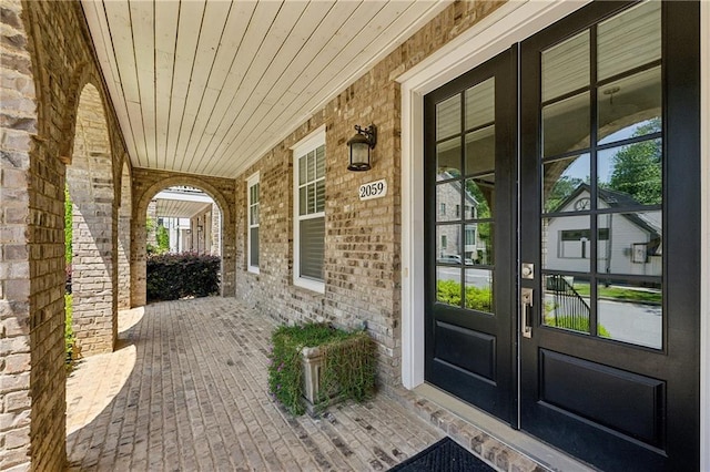 2059 Wheaton Way, Atlanta, GA 30328 - view of exterior entry featuring french doors, covered porch, and brick siding