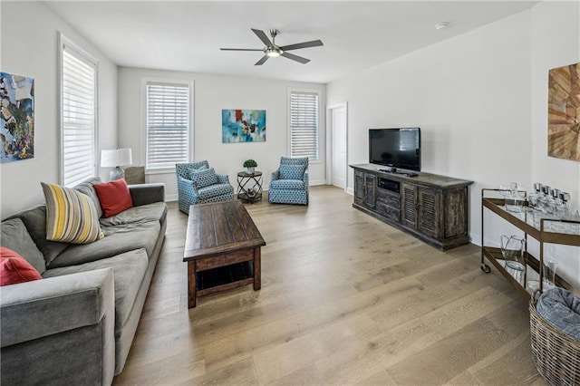 2059 Wheaton Way, Atlanta, GA 30328 - living room with healthy amount of natural light, light wood finished floors, and ceiling fan