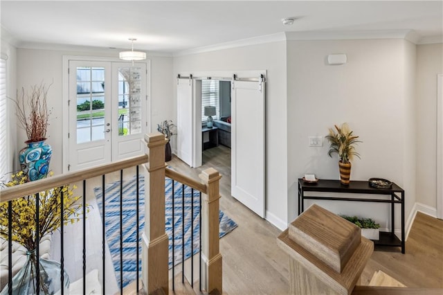 2059 Wheaton Way, Atlanta, GA 30328 - entryway featuring a barn door, healthy amount of natural light, light wood-style flooring, ornamental molding, and baseboards