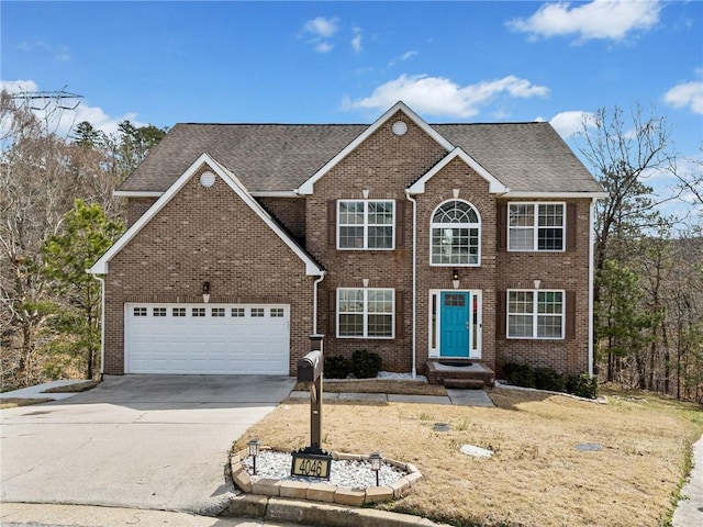 colonial-style house with concrete driveway, brick siding, a garage, and roof with shingles