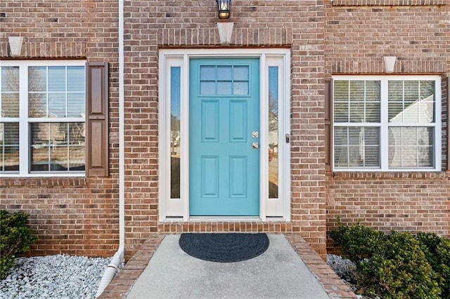 property entrance with brick siding