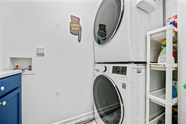 laundry area featuring laundry area and stacked washer / drying machine