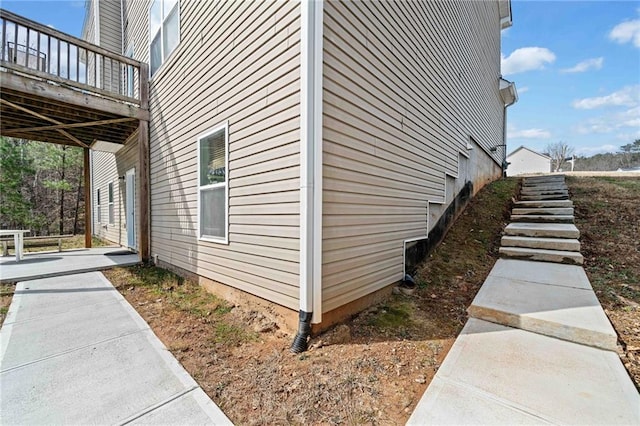 view of property exterior with a wooden deck