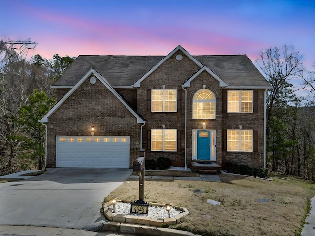 view of front facade featuring brick siding, concrete driveway, and a garage