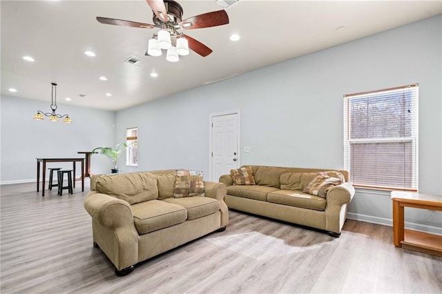 living area with light wood-style flooring, recessed lighting, visible vents, and baseboards