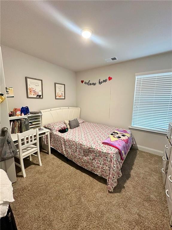 bedroom featuring visible vents, carpet flooring, and baseboards