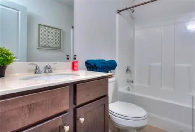 bathroom with bathing tub / shower combination, toilet, and vanity