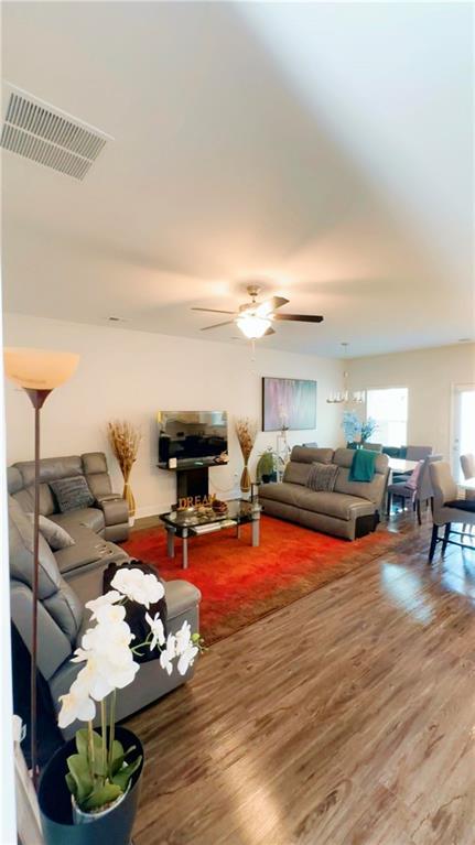 living room with hardwood / wood-style flooring and ceiling fan