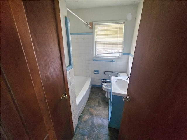 bathroom featuring vanity, toilet, and tile walls