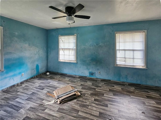 unfurnished room with dark hardwood / wood-style flooring and ceiling fan