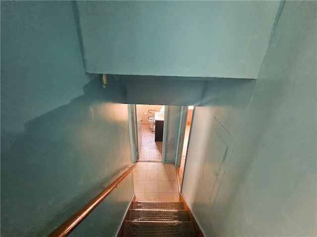 stairway featuring tile patterned floors