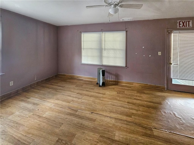 spare room featuring light wood-type flooring and ceiling fan