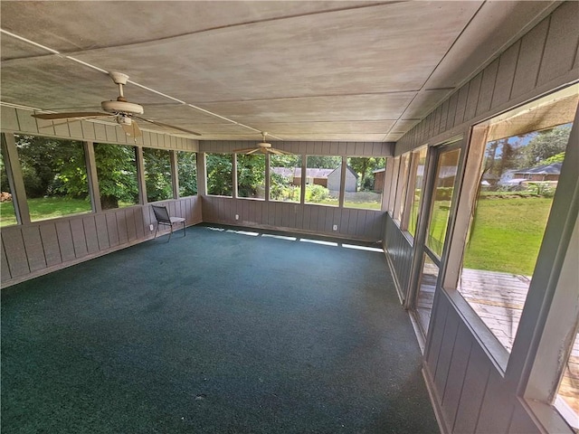 unfurnished sunroom with ceiling fan and a wealth of natural light