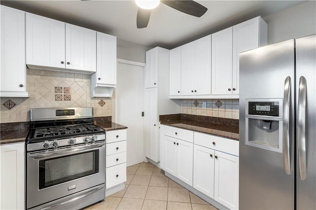 kitchen featuring light tile patterned floors, decorative backsplash, white cabinets, and stainless steel appliances