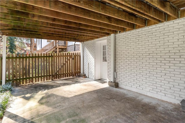 view of patio / terrace with stairway and fence