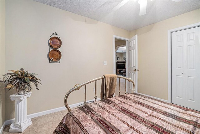 138 Victoria Ln, Lavonia, GA 30553 - carpeted bedroom featuring a textured ceiling, ceiling fan, baseboards, and a closet