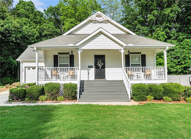 138 Victoria Ln, Lavonia, GA 30553 - view of front of house with covered porch, an attached garage, a shingled roof, and a front yard