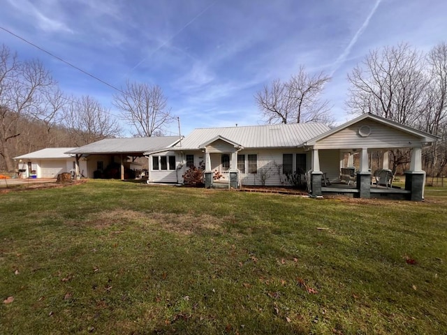 back of house with covered porch and a lawn