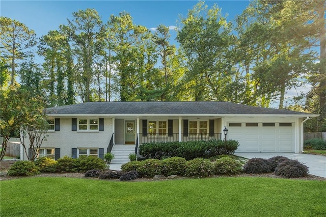 view of front facade with covered porch, a front yard, and a garage