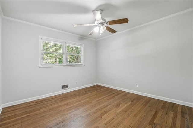 spare room with ornamental molding, hardwood / wood-style floors, and ceiling fan