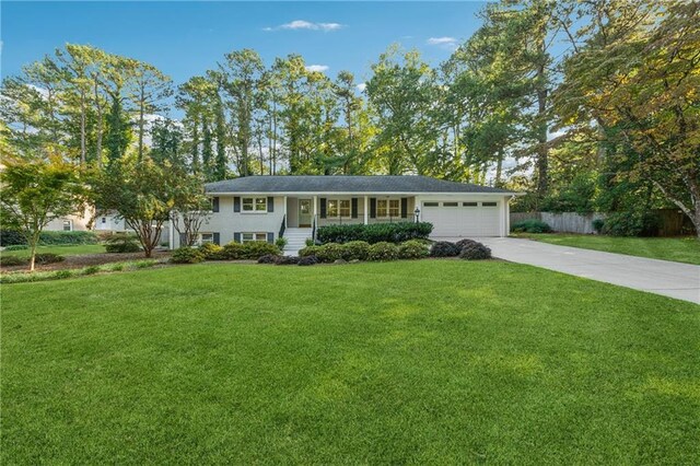 view of front of property with a garage and a front lawn