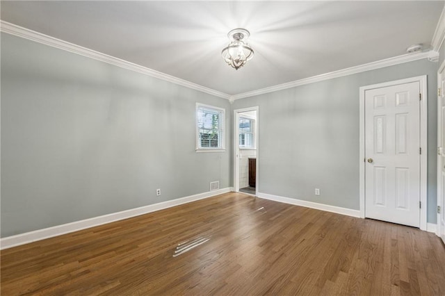 empty room featuring crown molding and hardwood / wood-style floors