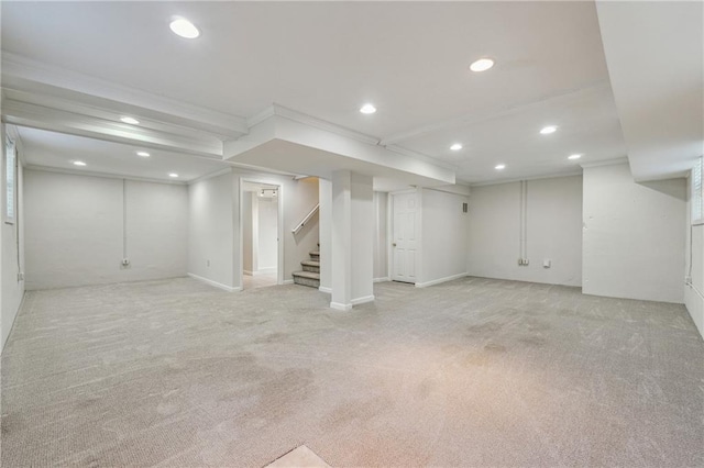 basement with light carpet and crown molding