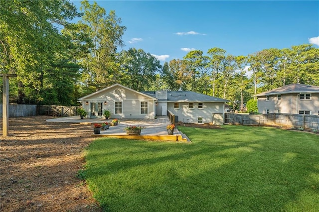 back of house featuring a yard, a patio area, and a deck