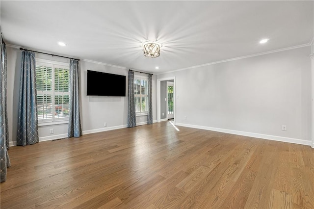 unfurnished living room featuring ornamental molding and light wood-type flooring