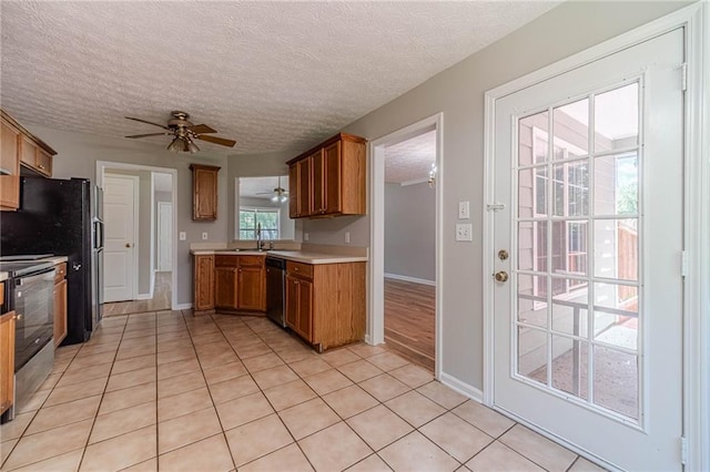 647 New England Way, Lawrenceville, GA 30046 - kitchen featuring stainless steel dishwasher, stove, brown cabinetry, a ceiling fan, and light countertops