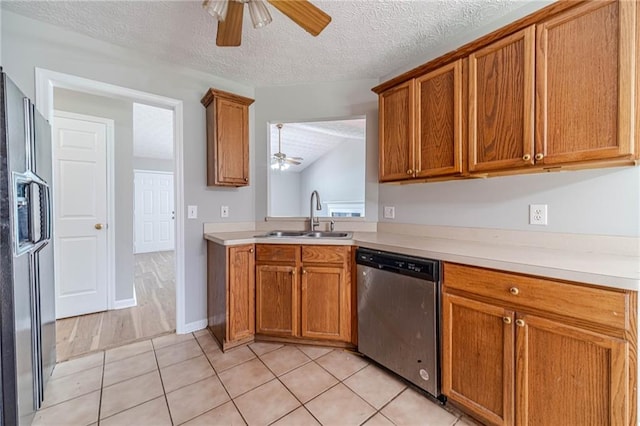 647 New England Way, Lawrenceville, GA 30046 - kitchen featuring appliances with stainless steel finishes, a ceiling fan, a sink, brown cabinetry, and a textured ceiling