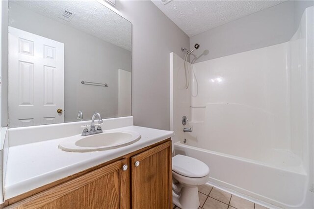 647 New England Way, Lawrenceville, GA 30046 - bathroom with toilet, tile patterned flooring, a textured ceiling, shower / bathtub combination, and vanity