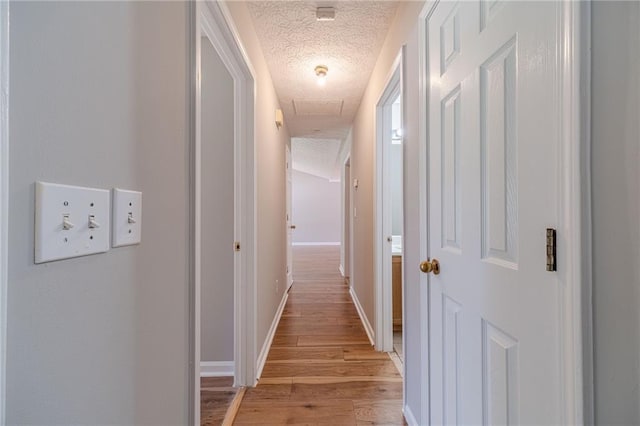 647 New England Way, Lawrenceville, GA 30046 - hallway featuring a textured ceiling, light wood-type flooring, and baseboards