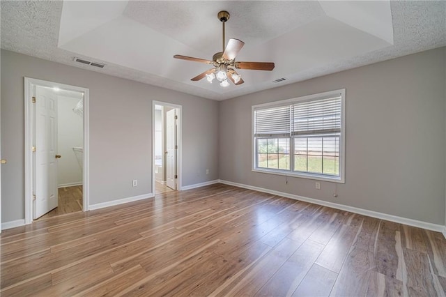 647 New England Way, Lawrenceville, GA 30046 - unfurnished bedroom with light wood-type flooring, baseboards, a spacious closet, a textured ceiling, and a ceiling fan