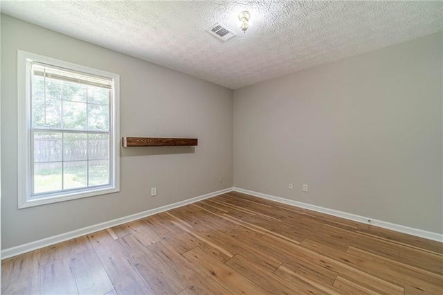 647 New England Way, Lawrenceville, GA 30046 - spare room featuring hardwood / wood-style flooring, baseboards, and a textured ceiling