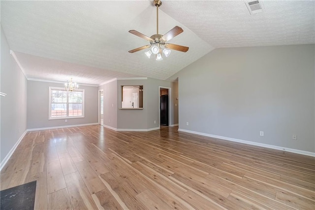 647 New England Way, Lawrenceville, GA 30046 - empty room with a chandelier, a ceiling fan, light wood finished floors, baseboards, and vaulted ceiling
