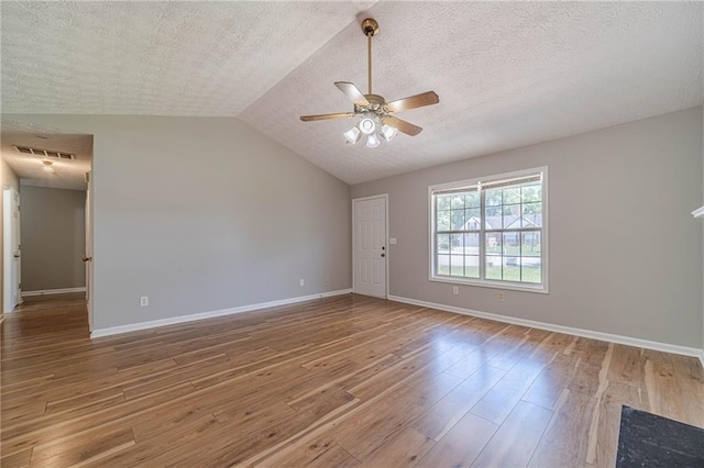 647 New England Way, Lawrenceville, GA 30046 - unfurnished room featuring a ceiling fan, wood finished floors, baseboards, a textured ceiling, and lofted ceiling