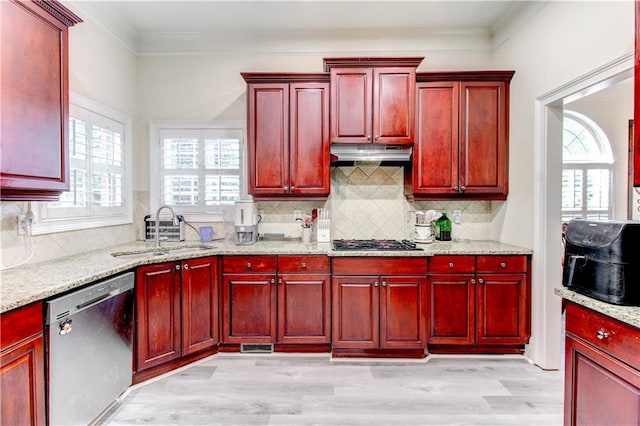 kitchen with decorative backsplash, appliances with stainless steel finishes, plenty of natural light, and sink