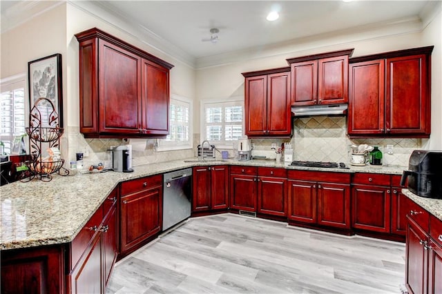 kitchen featuring a wealth of natural light, sink, appliances with stainless steel finishes, and light hardwood / wood-style flooring