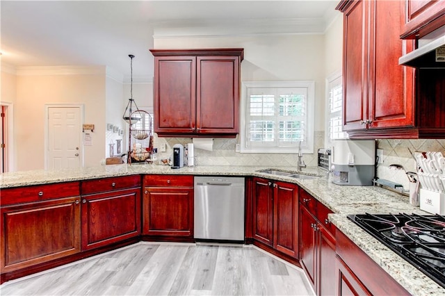 kitchen with light stone countertops, dishwasher, sink, black gas cooktop, and decorative light fixtures